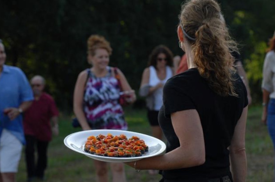 Servers passing hor d'oeuvres at outdoor event